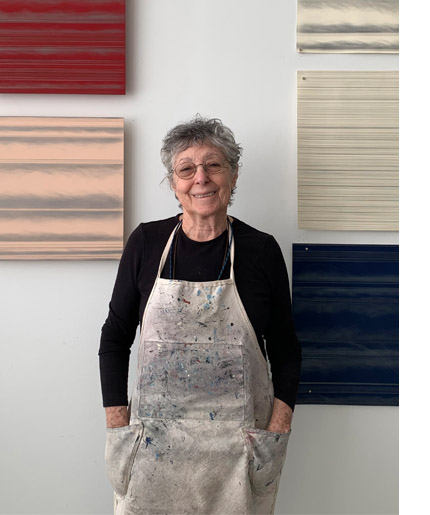 Susan Schwalb in the studio with her paintings and works on paper